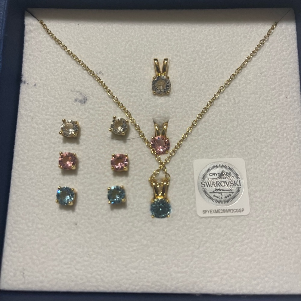 Aura crystals from Swarovski 3 sets of 3 earrings and 3 Necklaces NWT in OB